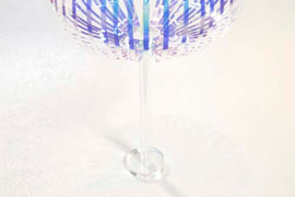 The Prodia Rainbow Stick Stand features a vibrant, multi-colored design with a transparent base. The stand is crafted to hold various items elegantly, showcasing its unique rainbow pattern that enhances any decor.