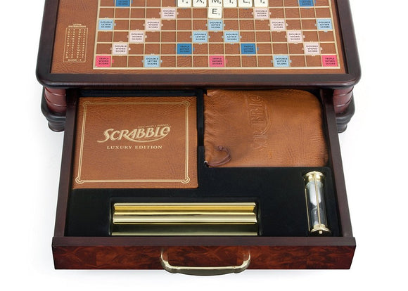 The Scrabble Luxury Edition game by Winning Solutions, featuring a premium game board with a rich, wooden frame, letter tiles in a leather pouch, score pads, and a timer, all stored elegantly in a spacious box.