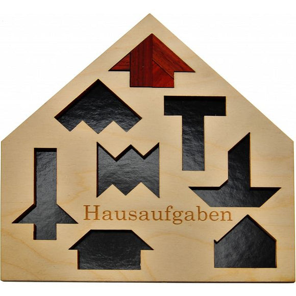 Hausaufgaben mechanical puzzle by Jean-Claude Constantin, featuring a wooden board shaped like a house with various geometric shapes to fit into cutouts. Designed for both adults and children, this puzzle enhances problem-solving skills and cognitive development.