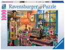 The Sewing Shed jigsaw puzzle by Ravensburger features a vibrant and cozy sewing studio. The scene includes colorful fabrics, a classic sewing machine, a lamp, and decorative items such as heart-shaped ornaments. A curious cat lounges on the crafting table, adding warmth to the inviting atmosphere. Large windows frame a picturesque view of nature outside, enhancing the overall charm of the workspace.