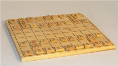 A folding Shogi board game set, featuring a wooden playing surface with a grid and engraved pieces. The board is arranged for play, showcasing its strategic design and classic Japanese artistry.