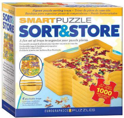 The Sort & Store Tray Set by Eurographics is a jigsaw puzzle accessory designed for sorting pieces. It features six stackable trays in a bright yellow color, helping to organize and manage puzzle pieces effectively while working on a 1000-piece puzzle. The packaging shows a visual of the trays in use with colorful puzzle pieces, emphasizing a fun and efficient way to enhance the puzzle-solving experience.