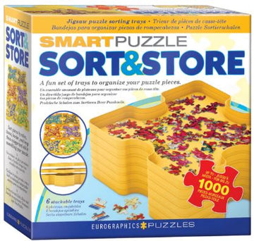 The Sort & Store Tray Set by Eurographics is a jigsaw puzzle accessory designed for sorting pieces. It features six stackable trays in a bright yellow color, helping to organize and manage puzzle pieces effectively while working on a 1000-piece puzzle. The packaging shows a visual of the trays in use with colorful puzzle pieces, emphasizing a fun and efficient way to enhance the puzzle-solving experience.