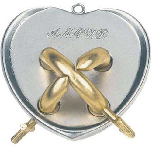 The Cast Amour mechanical puzzle by Hanayama features a heart-shaped design with intricate golden and silver interlocking pieces. The word 'AMOUR' is elegantly engraved on the surface, highlighting its romantic theme. Two key components are visible on the sides, indicating how the pieces interact in this challenging puzzle.