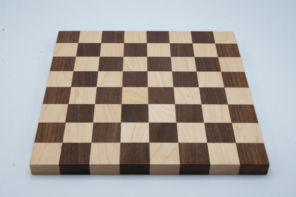 A beautifully crafted 12 inch chessboard featuring 1.5 inch squares, made from high-quality wood. The board has an alternating pattern of light and dark squares, perfect for an engaging game of chess.