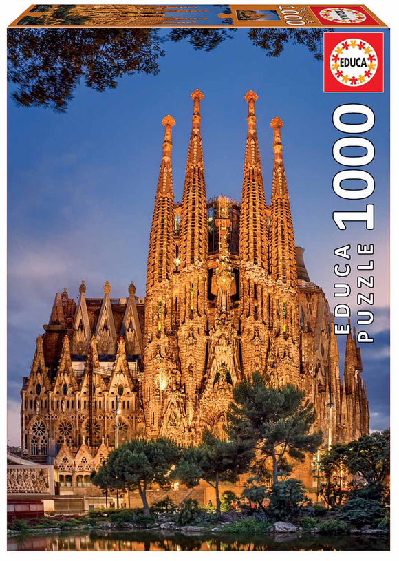 Educa Sagrada Familia 1000-piece jigsaw puzzle box featuring a stunning image of the Sagrada Familia basilica in Barcelona, showcasing intricate architectural details and vibrant colors under a twilight sky.