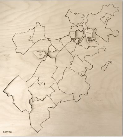 A detailed jigsaw puzzle featuring the neighborhoods of Boston, crafted from wood. The puzzle showcases the city’s layout with intricate cutouts representing different areas, presented on a light wooden background. Ideal for puzzle enthusiasts and Boston lovers alike, this unique piece combines art and entertainment.