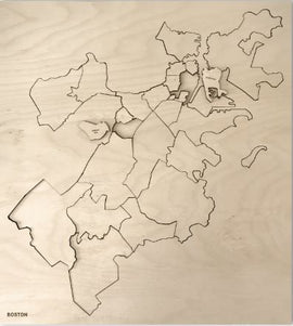 A detailed jigsaw puzzle featuring the neighborhoods of Boston, crafted from wood. The puzzle showcases the city’s layout with intricate cutouts representing different areas, presented on a light wooden background. Ideal for puzzle enthusiasts and Boston lovers alike, this unique piece combines art and entertainment.