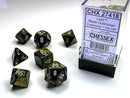 Chessex Leaf Black Gold/Silver Polyhedral 7-Dice Set featuring seven colorful dice in black with gold and silver numbers. Ideal for tabletop games and RPG enthusiasts, showcasing a stylish design.