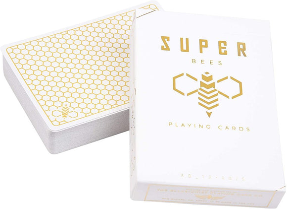 A deck of Super Bees playing cards from Ellusionist, featuring a sleek white box with gold honeycomb pattern and bee graphics. The cards are neatly stacked with a glossy finish, perfect for card games and magic tricks.