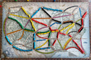 A close-up view of the Ticket to Ride board game by Days of Wonder, featuring a beautifully illustrated map of North America with colorful train routes made of plastic pieces in various colors including blue, yellow, green, black, red, and orange. The map showcases major cities connected by tracks, highlighting strategic gameplay elements.