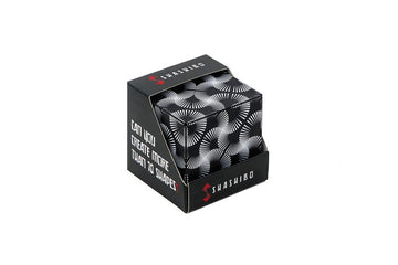 Shashibo Black & White box showing intricate black and white designs, featuring the question 'Can you create more than 70 shapes?' The box is sturdy and designed for multiple transformations, encouraging creativity through play.