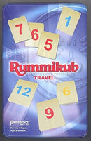Rummikub: Travel Tin game box featuring colorful number tiles 1 through 12, with a red and blue background, emphasizing the game's portable nature for 2 to 4 players aged 8 and older.