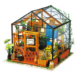 Cathy's Flower House Model Kit by Robotime, featuring a detailed greenhouse with vibrant plants, a blue door, and rustic decorations. Perfect for DIY enthusiasts, this kit includes miniature gardening tools and accessories, creating a charming floral display.