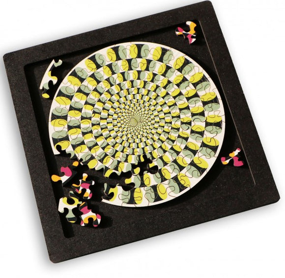 Curiosi Puzzle Tray Large featuring a colorful jigsaw puzzle with a spiral design. The tray is black with several puzzle pieces scattered around the incomplete puzzle, showcasing intricate patterns in vibrant colors including yellow, pink, and black.