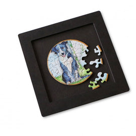 A small puzzle tray featuring a jigsaw puzzle with a circular image of a dog. Several jigsaw pieces are placed outside the tray, showcasing their vibrant colors and unique shapes. The tray is black, highlighting the vivid illustration of the dog, making it perfect for puzzle enthusiasts.