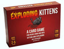 Exploding Kittens is a fun and quirky card game featuring a playful cartoon cat with a grenade, set against a fiery red background. The box highlights that it is suitable for ages 7 and up and can accommodate 2-5 players. It emphasizes a quick learning time of just 2 minutes and a gameplay duration of 15 minutes, making it perfect for parties or family gatherings.