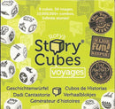 A box of Rory's Story Cubes Voyages. The packaging is bright yellow with the main title displaying 'Rory's Story Cubes' in bold letters. The box features images of nine dice, illustrating various travel-themed icons such as mountains, compasses, and suitcases. It boasts accolades including 'Dr. Toy 10 Best Games Winner' and 'Major Fun! Keeper!', emphasizing creativity and storytelling potential.