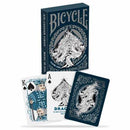 The Bicycle Dragon Card Deck features an intricate design with dragon illustrations on the playing cards. The deck includes the Ace of Spades and King of Spades, showcasing detailed artwork and vibrant colors against a dark background. The box is decorated with a striking dragon motif, making it an eye-catching addition to any card collection.