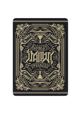 The Ultimate Deck - Stranger features an intricately designed back with a vintage artistic motif, showcasing ornamental elements and a bold typography. The card design is predominantly black and gold, creating a distinctive look suitable for magic tricks, card games, and collectors.