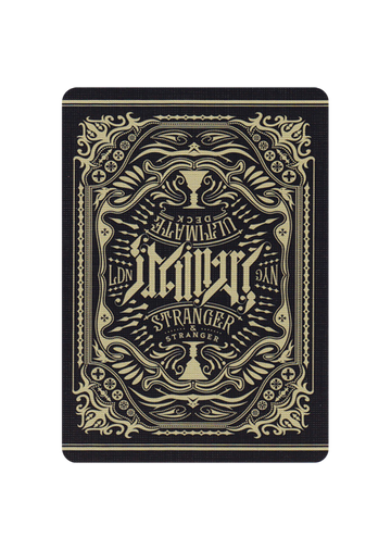 The Ultimate Deck - Stranger features an intricately designed back with a vintage artistic motif, showcasing ornamental elements and a bold typography. The card design is predominantly black and gold, creating a distinctive look suitable for magic tricks, card games, and collectors.