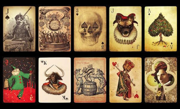 A collection of intricate playing cards from the Ultimate Deck - Stranger, featuring artistic designs including a skull, a festive character in green, a dog wearing a collar, and a decorated tree, among others. Each card showcases unique artwork and vibrant colors.