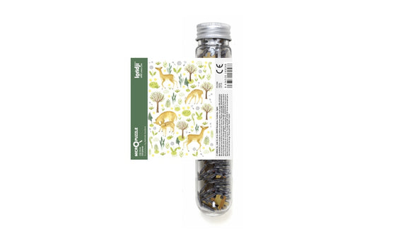 Micropuzzle Deers by Londji is a whimsical jigsaw puzzle contained in a transparent tube. The design features charming illustrations of deer and other woodland elements against a green background. Perfect for puzzle enthusiasts seeking a delightful challenge.