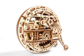 A detailed wooden DIY kit of a Monowheel from UGears 3D, showcasing intricate mechanical components and engraved instructions like 'STOP', 'FULL AHEAD' and 'UGears' on a circular body.