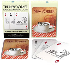A box of Cat Cartoons Playing Cards by New York Puzzle Company. The box features a playful image of a cat resting in a teacup. Inside, several playing cards showcase unique cartoons, including a cat by a bowl of food and other whimsical cat-themed illustrations. Perfect for game nights and cat lovers.