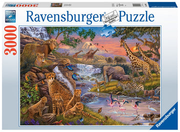 Ravensburger 'Animal Kingdom' jigsaw puzzle featuring a vivid scene of wildlife. The image includes lions, giraffes, zebras, elephants, and various birds near a waterfall and lush greenery. With 3000 pieces, this high-quality puzzle captivates nature enthusiasts and puzzle lovers alike.