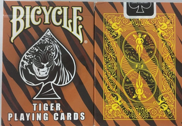 A deck of Bicycle Tiger Playing Cards featuring a striking black tiger image on the front, set against a vibrant orange and black striped background. The back design showcases intricate yellow illustrations with whimsical characters, offering a unique and captivating look for card enthusiasts and collectors.