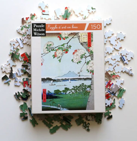 Apple Blossoms jigsaw puzzle by Wilson Jeux featuring a vibrant artwork of blooming apple trees against a scenic landscape. The puzzle is surrounded by its colorful pieces, showcasing artistic design and intricate details.