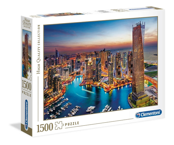 Clementoni Dubai Marina jigsaw puzzle box showcasing a vibrant aerial view of Dubai Marina at sunset, featuring high-rise buildings and a marina with yachts. The box indicates a high-quality collection puzzle with 1500 pieces.