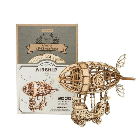 An Airship 3D Puzzle Kit by Robotime displayed with its packaging. The intricately designed wooden airship features a detailed body with a balloon, propellers, and a small wagon underneath. The kit includes 176 pieces and offers a fun DIY experience for puzzle enthusiasts. Ideal for building and displaying.