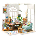 The SOHO Time DIY Miniature House Model Kit features a charming miniature room with a desk, chair, bookshelves, and decorative items. The scene includes plants, a cozy armchair, and artistic wall decor, perfect for hobbyists and collectors. This intricately designed DIY kit allows you to create an inviting living space filled with details.