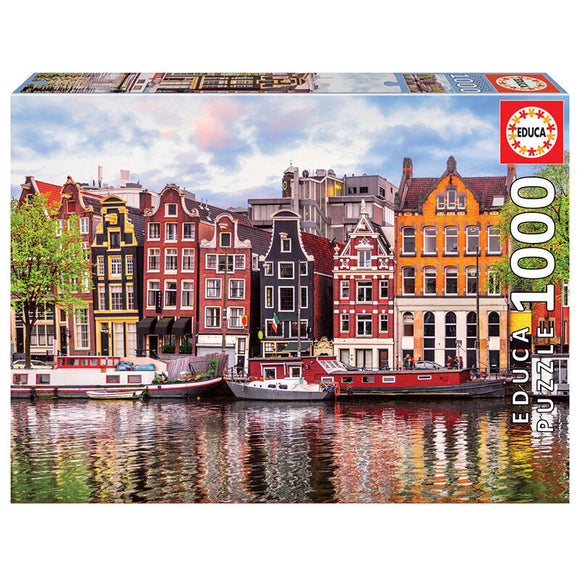 Educa 1000-piece jigsaw puzzle featuring the iconic Dancing Houses of Amsterdam, showcasing intricate details of the colorful canal-side buildings and boats reflecting in the water.