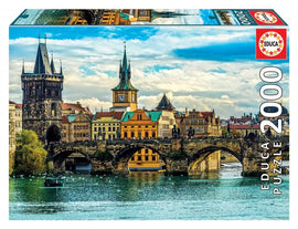 Educa jigsaw puzzle featuring a stunning view of Prague. The image showcases the iconic Charles Bridge along with picturesque buildings and a tranquil river. Perfect for puzzle enthusiasts, this 2000-piece puzzle captures the beauty of Prague’s architecture and scenic landscapes, offering a rewarding challenge for ages 12 and up.