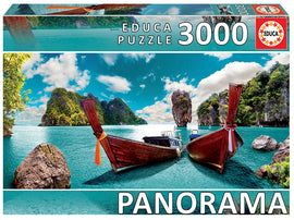 3000-piece jigsaw puzzle depicting a stunning, panoramic view of Phuket, Thailand. Features traditional wooden boats moored in turquoise waters, surrounded by lush green islands and a dramatic sky.