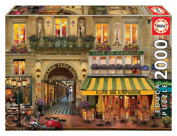 GALERIE PARIS jigsaw puzzle by Educa featuring a vibrant Parisian street scene with cafes, flowers, and classic architecture, designed for puzzle enthusiasts.
