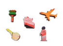 Colorful wooden jigsaw puzzle pieces featuring a variety of shapes including a gas station sign, an airplane, a boot, and a key, showcasing whimsical designs that are part of the Sunset On Old Montauk Highway jigsaw puzzle by Grant Haffner.