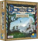The box cover of the board game 'Dominion: Menagerie' by Rio Grande Games. It features a fantastical landscape with a castle in the background, forest scenes, and silhouettes of various animals including deer and birds. The title 'Dominion' is prominently displayed in a decorative font, alongside the subtitle 'Menagerie'. The design reflects a mystical theme, suitable for the expansion of the popular Dominion game.