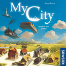 The game box for 'My City' by Thames & Kosmos features a vibrant illustration of a colorful landscape with various floating buildings and structures representing a developing city. The title is prominently displayed at the top, accompanied by the tagline 'Manifest Your Destiny.' The design is whimsical and invites players into a unique game experience.