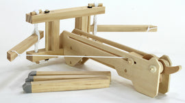 The Roman Ballista by Pathfinders is a wooden DIY kit designed to resemble the ancient siege weapon. It features intricate wooden parts, including a base, levers, and a string mechanism, allowing for hands-on assembly and interactive play.
