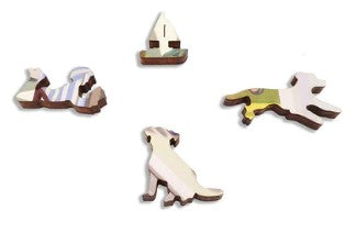 A close-up of four uniquely shaped pieces from 'The Sunday Paper' jigsaw puzzle by Kathryn Freeman, featuring a dog, a sailboat, and abstract designs in soft colors. Each piece has a distinct shape and intricate patterns, showcasing the artistic design and craftsmanship of Artifact Wooden Puzzles.