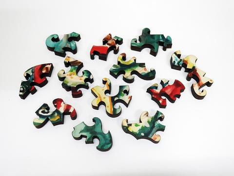 A colorful array of jigsaw puzzle pieces from the Bucket o' Fish product by Artifact Wooden Puzzles, showcasing intricate shapes and vibrant patterns, perfect for puzzlers of all ages.
