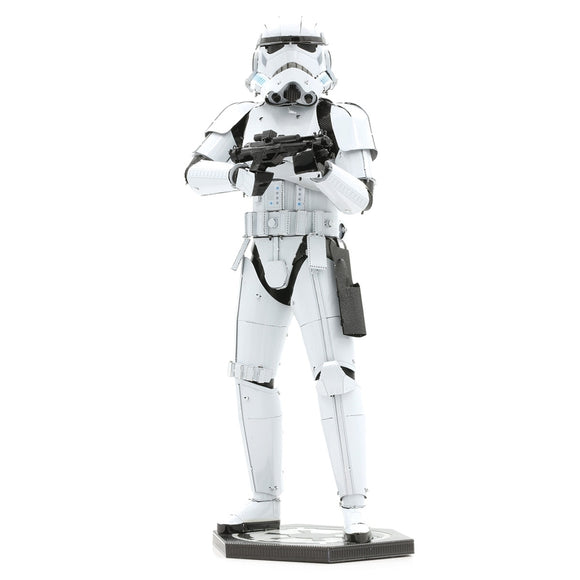 The ICONX: Stormtrooper by Fascinations is a detailed metal model kit depicting a Stormtrooper from the Star Wars franchise, featuring intricate design and metallic finish. The figure stands in a dynamic pose, holding a blaster, with visible details such as armor plating and weaponry, ideal for display or crafting.