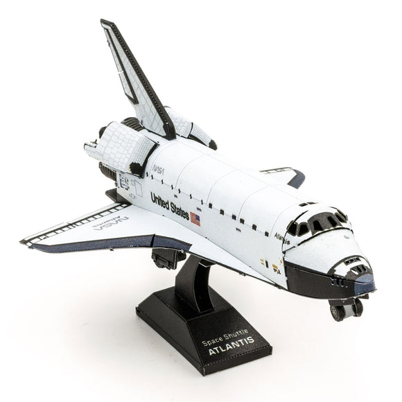 A detailed metal model of the Space Shuttle Atlantis from Fascinations. The shuttle features intricate designs, displaying its iconic shape and NASA insignia, mounted on a black base.