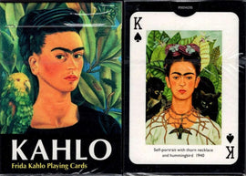 A deck of Frida Kahlo playing cards featuring a vibrant illustration of Kahlo surrounded by green leaves and a parrot on the front. The card shows a representation of her iconic self-portrait with thorn necklace and hummingbird on the back.