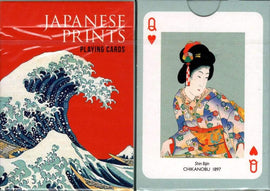 A pack of playing cards featuring Japanese prints. The front of the box showcases a vibrant red background with an iconic wave design inspired by Hokusai. The heart queen card displays a traditional Japanese woman in colorful attire, with intricate details and historical significance.