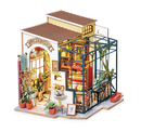 Emily's Flower Shop DIY Model Kit by Robotime, featuring a detailed miniature flower shop complete with vibrant plants, colorful interiors, and an inviting exterior. This DIY kit offers an engaging building experience for craft lovers, showcasing intricate design elements and a charming aesthetic.
